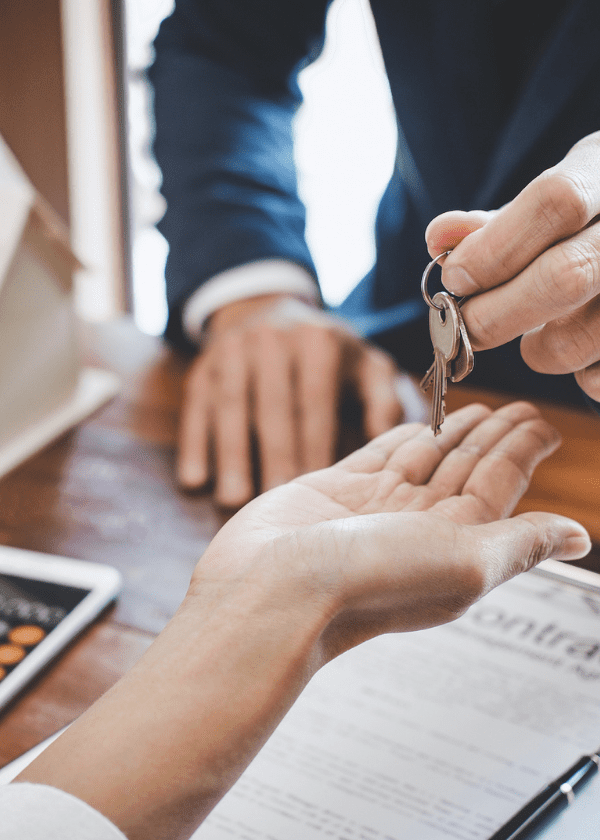 a person handing keys over to another person